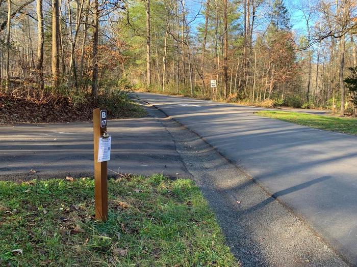 A blacktop road with a small brown post.B-17 back-in angle.