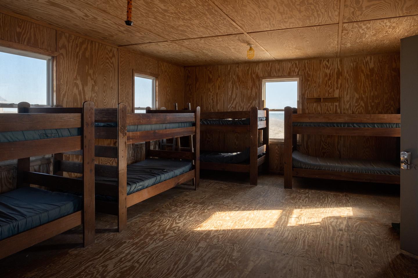 A view of the living room / bedroom area showing 4 bunk beds.Living room/bedroom area.