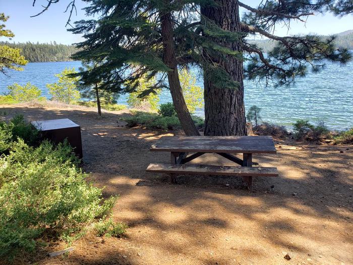 Beautiful waterfront site that features a picnic table, fire ring, and bear box.Sundew Site 18