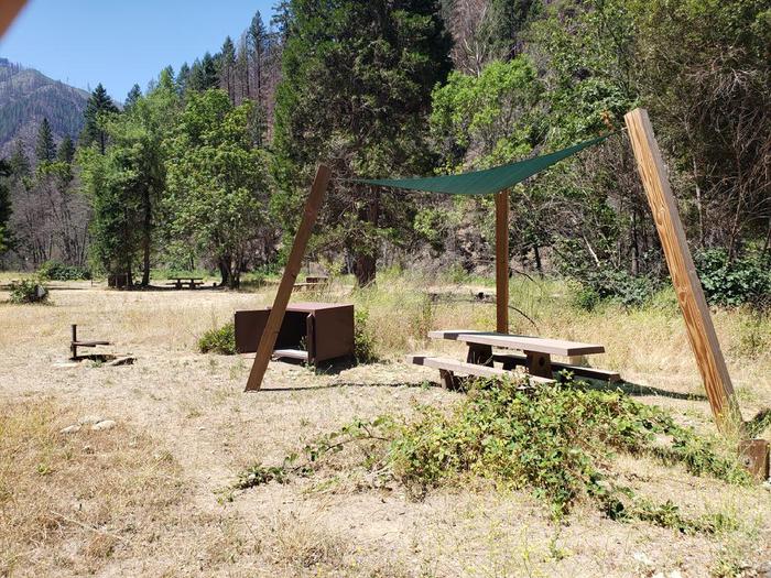 Spacious site featuring a picnic table, sun shade, fire ring, and bear box.Gansner Bar Site 2