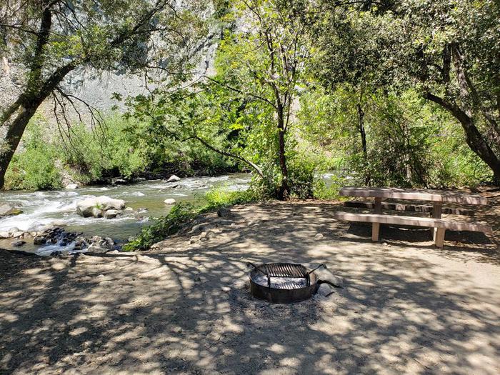 Beautiful waterfront site featuring a picnic table, fire ring, and bear box.Queen Lily Site 8