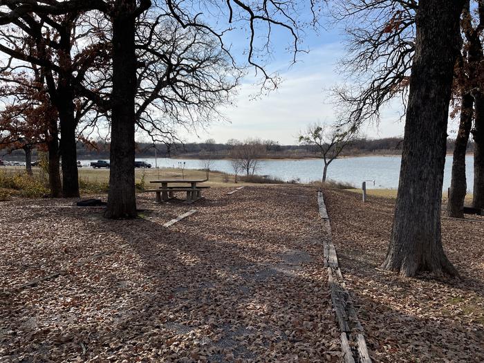 A photo of Site 40 of Loop JCRE at JOHNSON CREEK with Picnic Table, Electricity Hookup, Fire Pit, Shade, Waterfront, Water Hookup