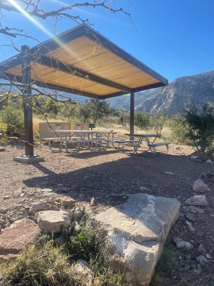 Shade structure, picnic tables, bear boxes, and grill with mountains in the backgroundShade structure, picnic tables, bear boxes, and grill 