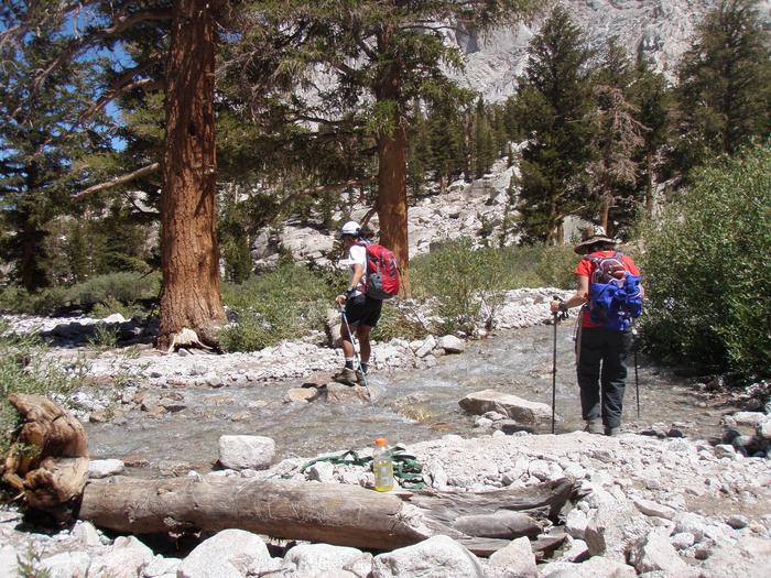 Hikers crossing stream on the Mount Whitney TrailWilderness hikers encounter a stream crossing.