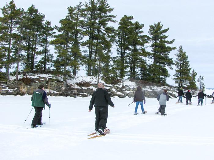 Visitors snowshoeing near an island on Rainy Lake in VNPVisitors snowshoeing near an island on Rainy Lake in Voyageurs National Park