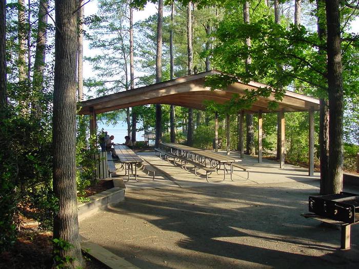 Multiple picnic tables, 2 grills, access to beach, playground, volleyball and horseshoe pits West Dam Group Shelter