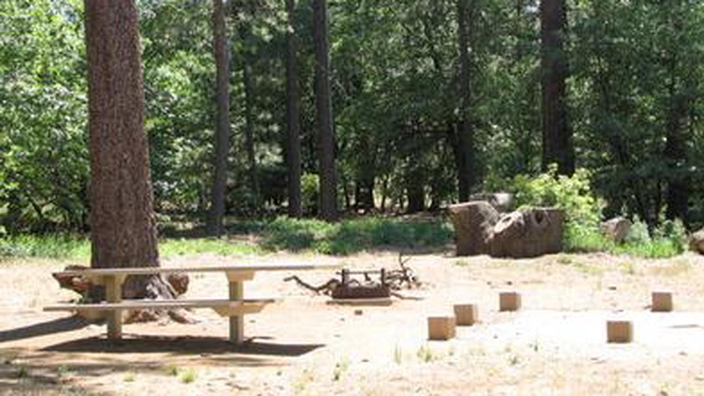 Flat sandy campsite with a picnic table and fire pit.BURNT RANCHERIA