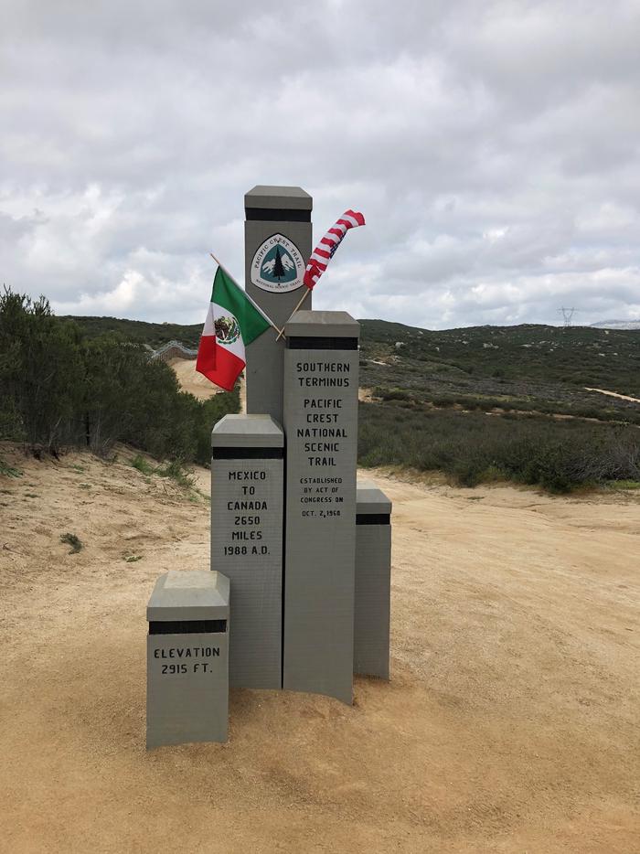 Pacific Crest Trail Southern Terminus monument with USA and Mexico flags.Pacific Crest Trail Southern Terminus Monument
