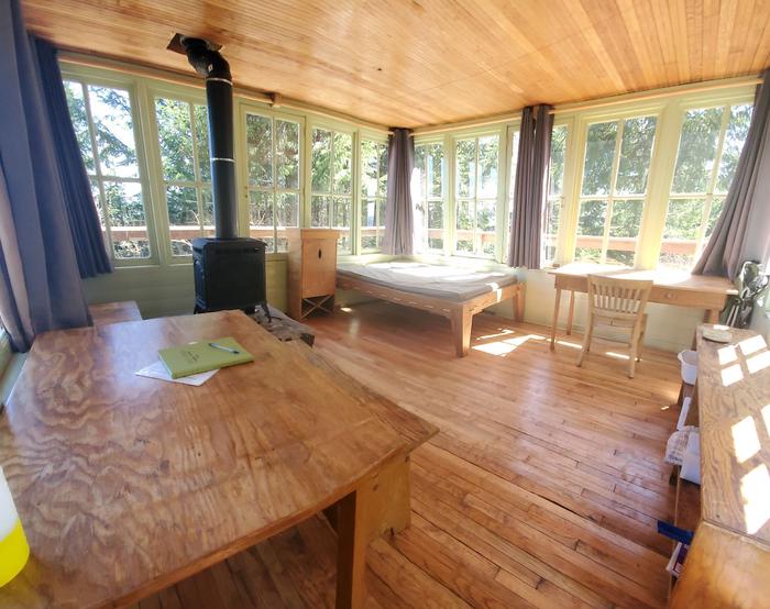 Timber Butte Cabin interior with stove, bed and desk.Timber Butte Cabin Interior