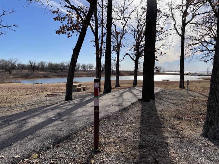 A photo of Site B22 of Loop B at LAKESIDE (OK) with Picnic Table, Electricity Hookup, Fire Pit, Shade, Waterfront, Water Hookup