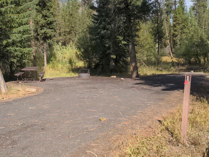 Paved parking area at campsite, with fire pit and picnic table. Campsite 1 at Poverty Flat Campground.Campsite 1 at Poverty Flat Campground.