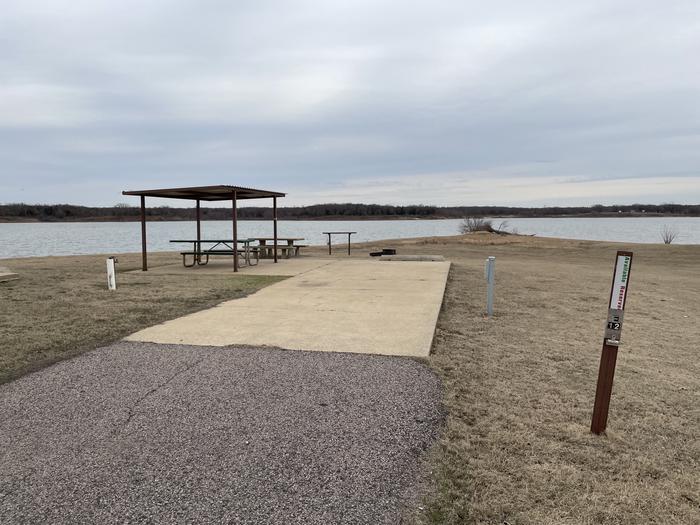 A photo of Site E12 of Loop E at LAKESIDE (OK) with Picnic Table, Electricity Hookup, Fire Pit, Waterfront, Water Hookup