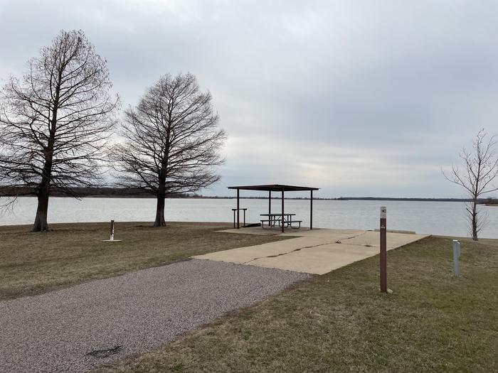 A photo of Site E09 of Loop E at LAKESIDE (OK) with Picnic Table, Electricity Hookup, Fire Pit, Waterfront, Water Hookup