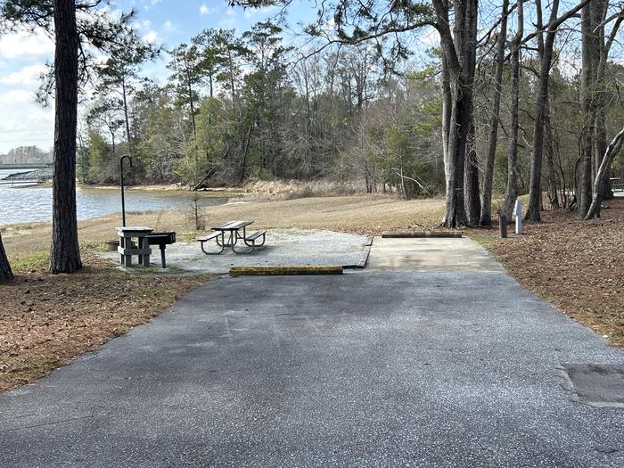A photo of Site 002 of Loop MPOI at WHITE OAK (CREEK) CAMPGROUND with Picnic Table, Electricity Hookup, Fire Pit, Shade, Waterfront, Lantern Pole, Water Hookup