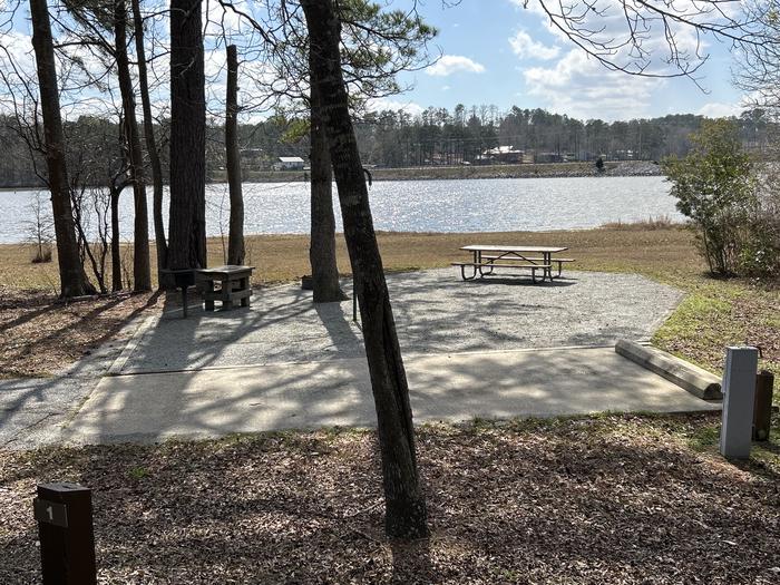 A photo of Site 001 of Loop MPOI at WHITE OAK (CREEK) CAMPGROUND with Picnic Table, Electricity Hookup, Fire Pit, Shade, Tent Pad, Waterfront, Lantern Pole, Water Hookup