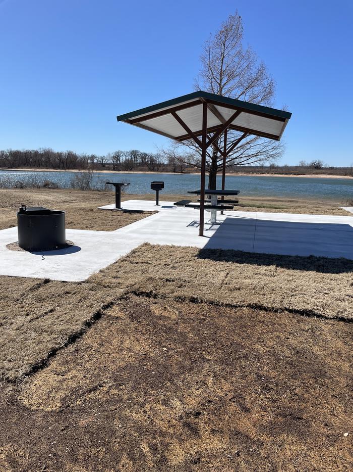 A photo of Site 011 of Loop BRUE at BURNS RUN EAST with Picnic Table, Electricity Hookup, Fire Pit, Shade, Waterfront, Water Hookup