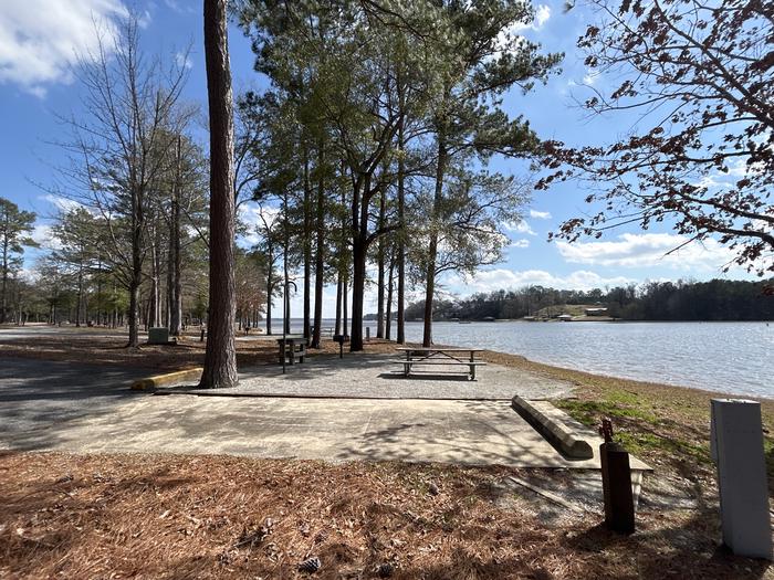 A photo of Site 003 of Loop MPOI at WHITE OAK (CREEK) CAMPGROUND with Picnic Table, Electricity Hookup, Fire Pit, Shade, Waterfront, Lantern Pole, Water Hookup