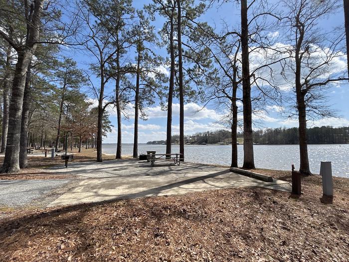 A photo of Site 004 of Loop MPOI at WHITE OAK (CREEK) CAMPGROUND with Picnic Table, Electricity Hookup, Fire Pit, Shade, Waterfront, Lantern Pole, Water Hookup