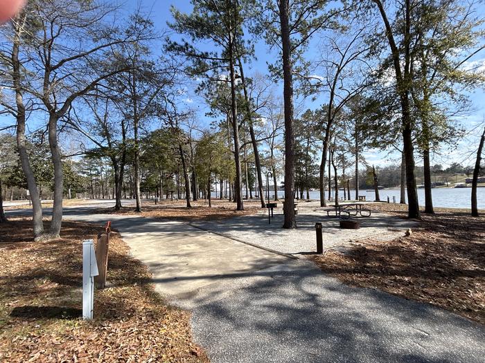 A photo of Site 007 of Loop MPOI at WHITE OAK (CREEK) CAMPGROUND with Picnic Table, Electricity Hookup, Fire Pit, Shade, Waterfront, Lantern Pole, Water Hookup