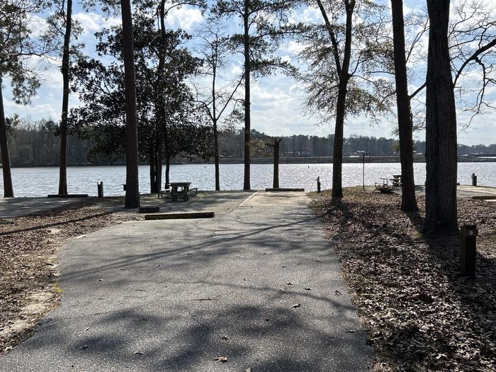 A photo of Site 009 of Loop MPOI at WHITE OAK (CREEK) CAMPGROUND with Picnic Table, Electricity Hookup, Fire Pit, Shade, Waterfront, Lantern Pole, Water Hookup