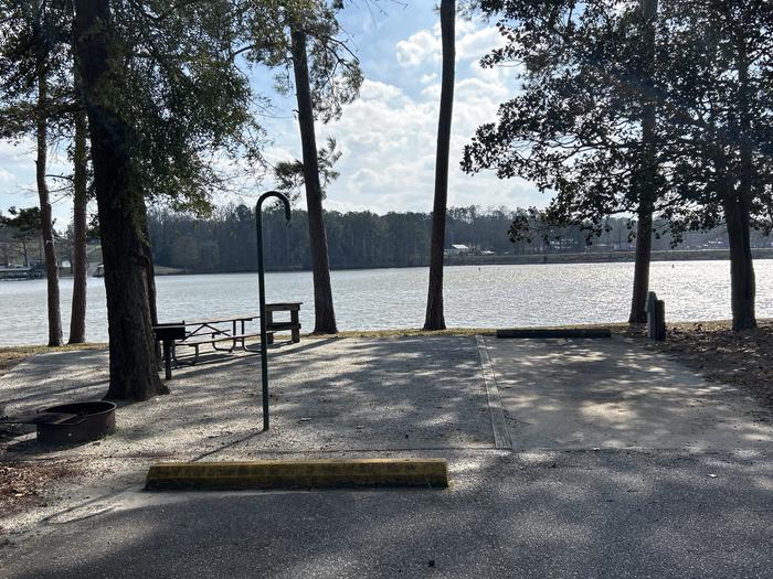 A photo of Site 010 of Loop MPOI at WHITE OAK (CREEK) CAMPGROUND with Picnic Table, Electricity Hookup, Fire Pit, Waterfront, Lantern Pole, Water Hookup