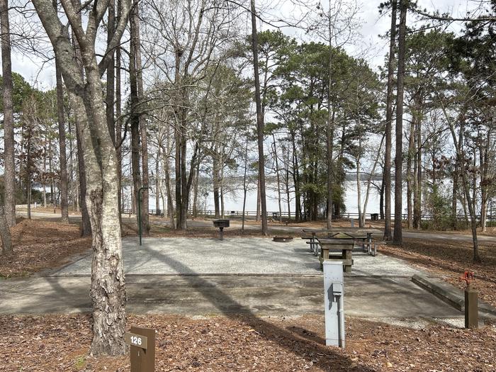A photo of Site 126 of Loop RCHA at WHITE OAK (CREEK) CAMPGROUND with Picnic Table, Electricity Hookup, Fire Pit, Shade, Waterfront, Lantern Pole, Water Hookup
