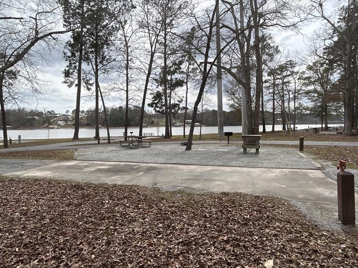 A photo of Site 017 of Loop MPOI at WHITE OAK (CREEK) CAMPGROUND with Picnic Table, Electricity Hookup, Fire Pit, Shade, Waterfront, Lantern Pole, Water Hookup