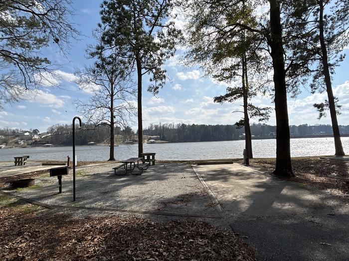 A photo of Site 011 of Loop MPOI at WHITE OAK (CREEK) CAMPGROUND with Picnic Table, Electricity Hookup, Fire Pit, Shade, Waterfront, Lantern Pole, Water Hookup