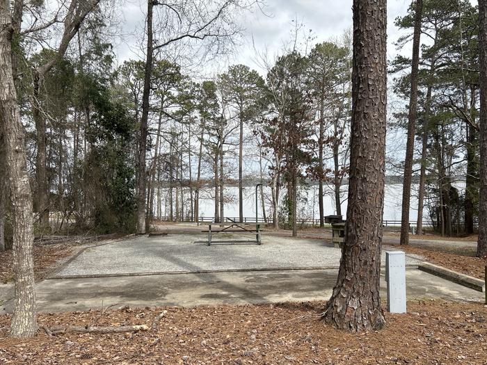 A photo of Site 125 of Loop RCHA at WHITE OAK (CREEK) CAMPGROUND with Picnic Table, Electricity Hookup, Fire Pit, Shade, Waterfront, Lantern Pole, Water Hookup