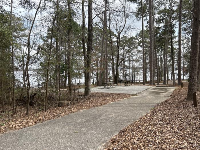 A photo of Site 125 of Loop RCHA at WHITE OAK (CREEK) CAMPGROUND with Picnic Table, Electricity Hookup, Sewer Hookup, Fire Pit, Shade, Waterfront, Lantern Pole, Water Hookup