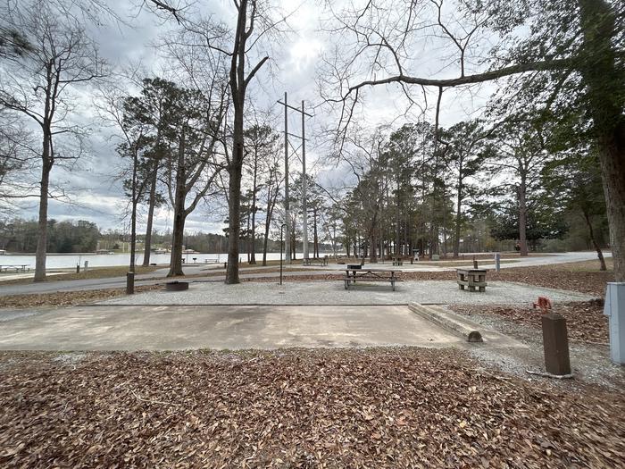 A photo of Site 019 of Loop MPOI at WHITE OAK (CREEK) CAMPGROUND with Picnic Table, Electricity Hookup, Fire Pit, Waterfront, Lantern Pole, Water Hookup