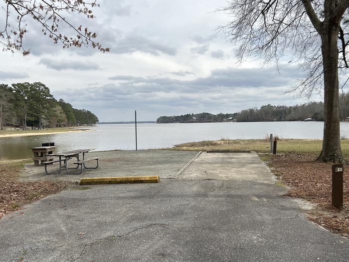 A photo of Site 022 of Loop MPOI at WHITE OAK (CREEK) CAMPGROUND with Picnic Table, Electricity Hookup, Fire Pit, Waterfront, Lantern Pole, Water Hookup