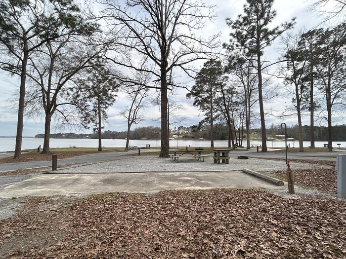 A photo of Site 023 of Loop MPOI at WHITE OAK (CREEK) CAMPGROUND with Picnic Table, Electricity Hookup, Fire Pit, Shade, Waterfront, Lantern Pole, Water Hookup