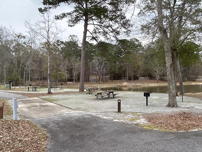 A photo of Site 026 of Loop MPOI at WHITE OAK (CREEK) CAMPGROUND with Picnic Table, Electricity Hookup, Fire Pit, Shade, Waterfront, Lantern Pole, Water Hookup