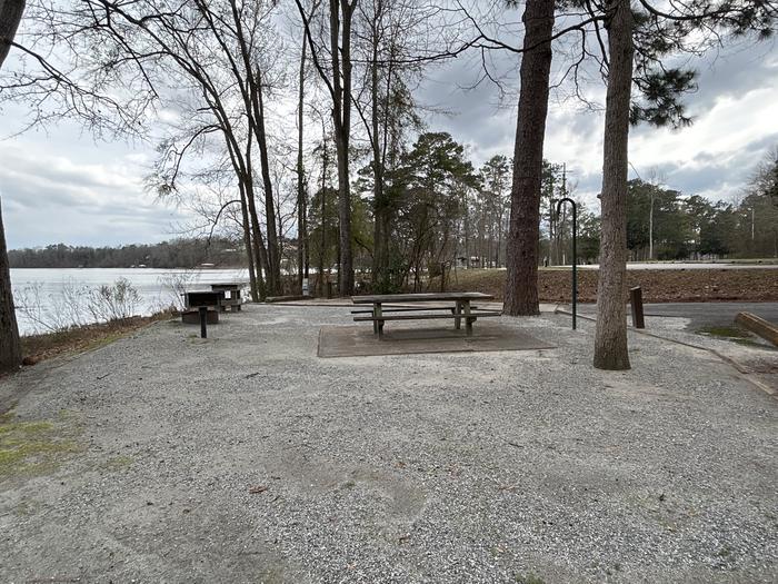A photo of Site 029 of Loop MPOI at WHITE OAK (CREEK) CAMPGROUND with Picnic Table, Electricity Hookup, Fire Pit, Shade, Waterfront, Lantern Pole, Water Hookup