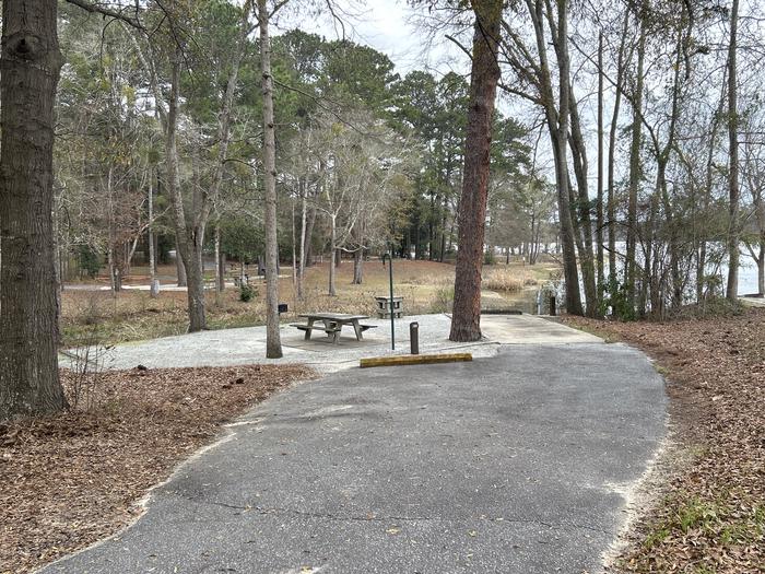 A photo of Site 029 of Loop MPOI at WHITE OAK (CREEK) CAMPGROUND with Picnic Table, Electricity Hookup, Fire Pit, Shade, Waterfront, Lantern Pole, Water Hookup