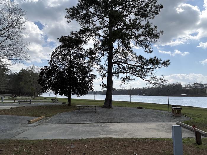 A photo of Site 041 of Loop OAKW at WHITE OAK (CREEK) CAMPGROUND with Picnic Table, Electricity Hookup, Fire Pit, Shade, Waterfront, Lantern Pole, Water Hookup