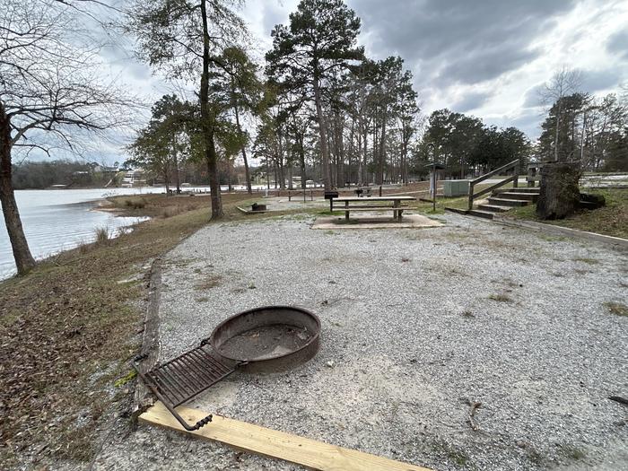 A photo of Site 028 of Loop MPOI at WHITE OAK (CREEK) CAMPGROUND with Picnic Table, Electricity Hookup, Fire Pit, Waterfront, Lantern Pole, Water Hookup