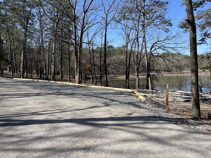 A photo of Site 18 of Loop A at Crystal Springs (AR) with Picnic Table, Electricity Hookup, Fire Pit, Tent Pad, Water Hookup, parking 