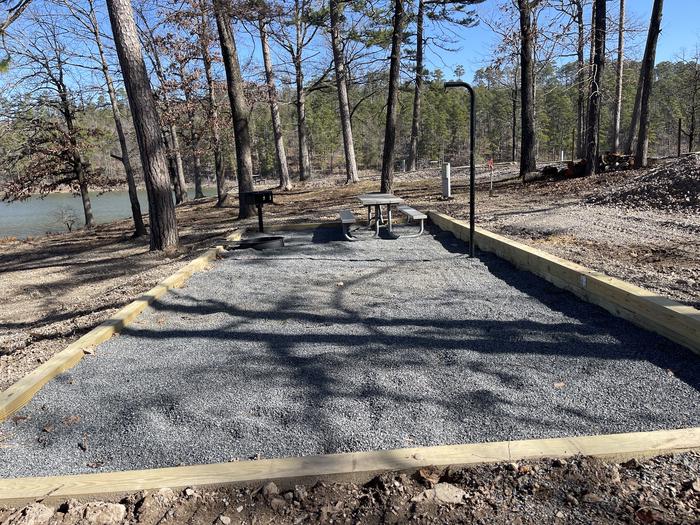 A photo of Site 18 of Loop A at Crystal Springs (AR) with Picnic Table, Electricity Hookup, Fire Pit, Tent Pad, Lantern Pole, Water Hookup