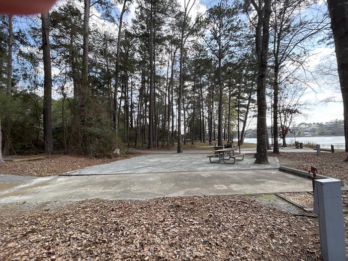 A photo of Site 031 of Loop OAKW at WHITE OAK (CREEK) CAMPGROUND with Picnic Table, Electricity Hookup, Fire Pit, Shade, Waterfront, Lantern Pole, Water Hookup