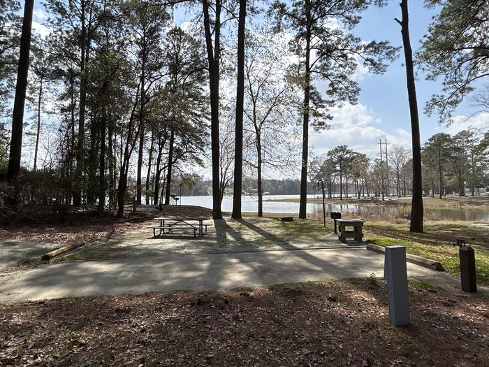 A photo of Site 034 of Loop OAKW at WHITE OAK (CREEK) CAMPGROUND with Picnic Table, Electricity Hookup, Fire Pit, Shade, Waterfront, Lantern Pole, Water Hookup