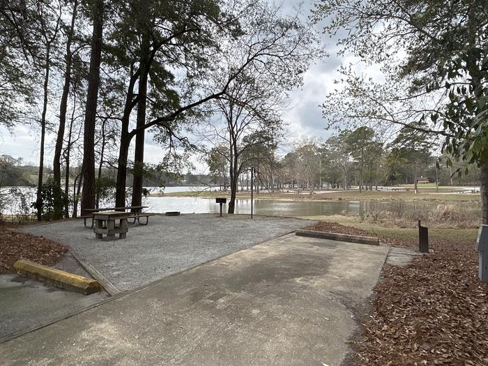 A photo of Site 035 of Loop OAKW at WHITE OAK (CREEK) CAMPGROUND with Picnic Table, Electricity Hookup, Fire Pit, Shade, Waterfront, Lantern Pole