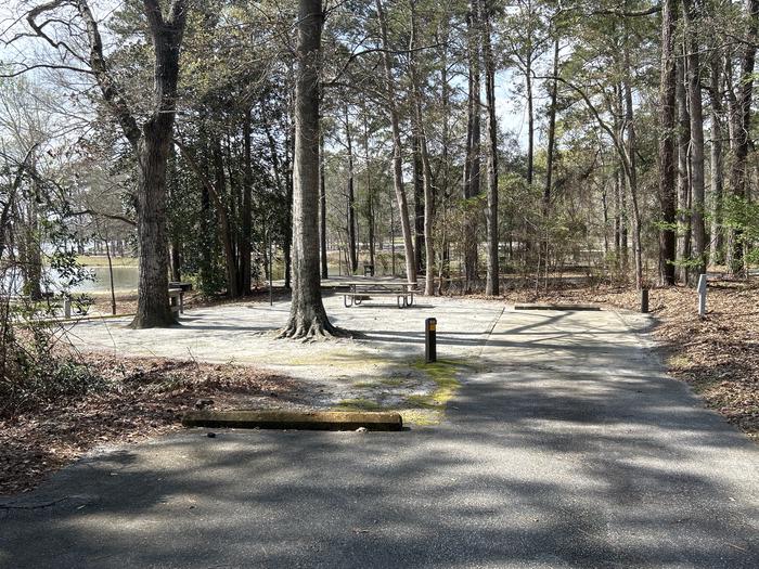 A photo of Site 052 of Loop OAKW at WHITE OAK (CREEK) CAMPGROUND with Picnic Table, Electricity Hookup, Fire Pit, Shade, Waterfront, Lantern Pole, Water Hookup