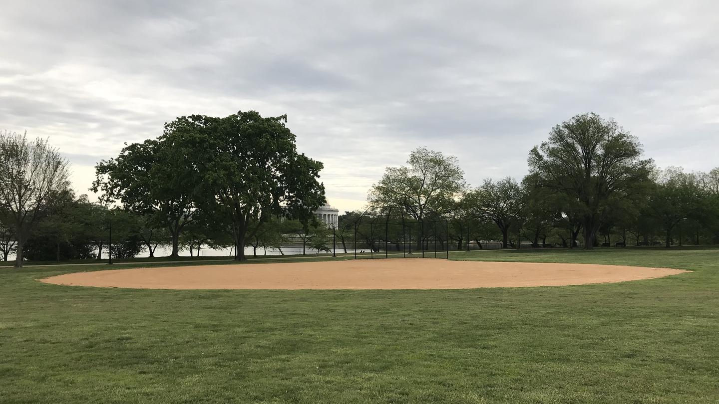 A View of field S1, featuring an an outfield, infield, and backstop, with trees, the Tidal Basin and the Thomas Jefferson Memorial in the background.A View of field S1 with the Tidal Basin and the Thomas Jefferson Memorial in the background.