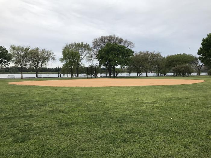 A view of field S3, featuring an outfield, infield, and backstop. In the background, the Potomac River is visible.A view of field S3 with the Potomac River in the background.
