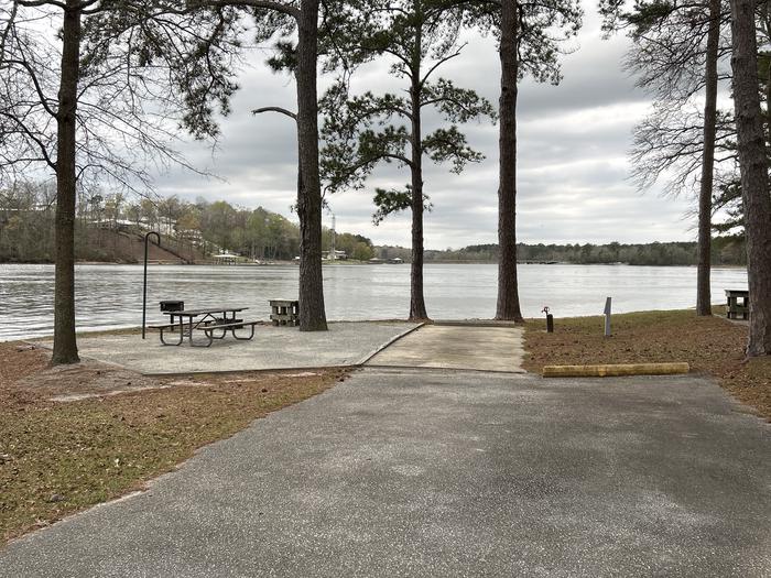 A photo of Site 073 of Loop CVIE at WHITE OAK (CREEK) CAMPGROUND with Picnic Table, Electricity Hookup, Fire Pit, Shade, Waterfront, Lantern Pole, Water Hookup