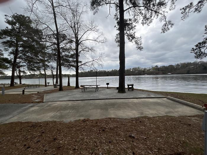 A photo of Site 073 of Loop CVIE at WHITE OAK (CREEK) CAMPGROUND with Picnic Table, Electricity Hookup, Fire Pit, Shade, Waterfront, Lantern Pole, Water Hookup