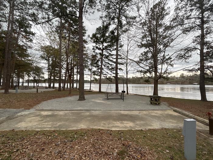 A photo of Site 070 of Loop CVIE at WHITE OAK (CREEK) CAMPGROUND with Picnic Table, Electricity Hookup, Fire Pit, Shade, Waterfront, Lantern Pole, Water Hookup