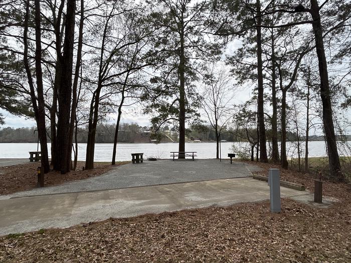 A photo of Site 049 of Loop OAKW at WHITE OAK (CREEK) CAMPGROUND with Picnic Table, Electricity Hookup, Fire Pit, Shade, Waterfront, Lantern Pole, Water Hookup